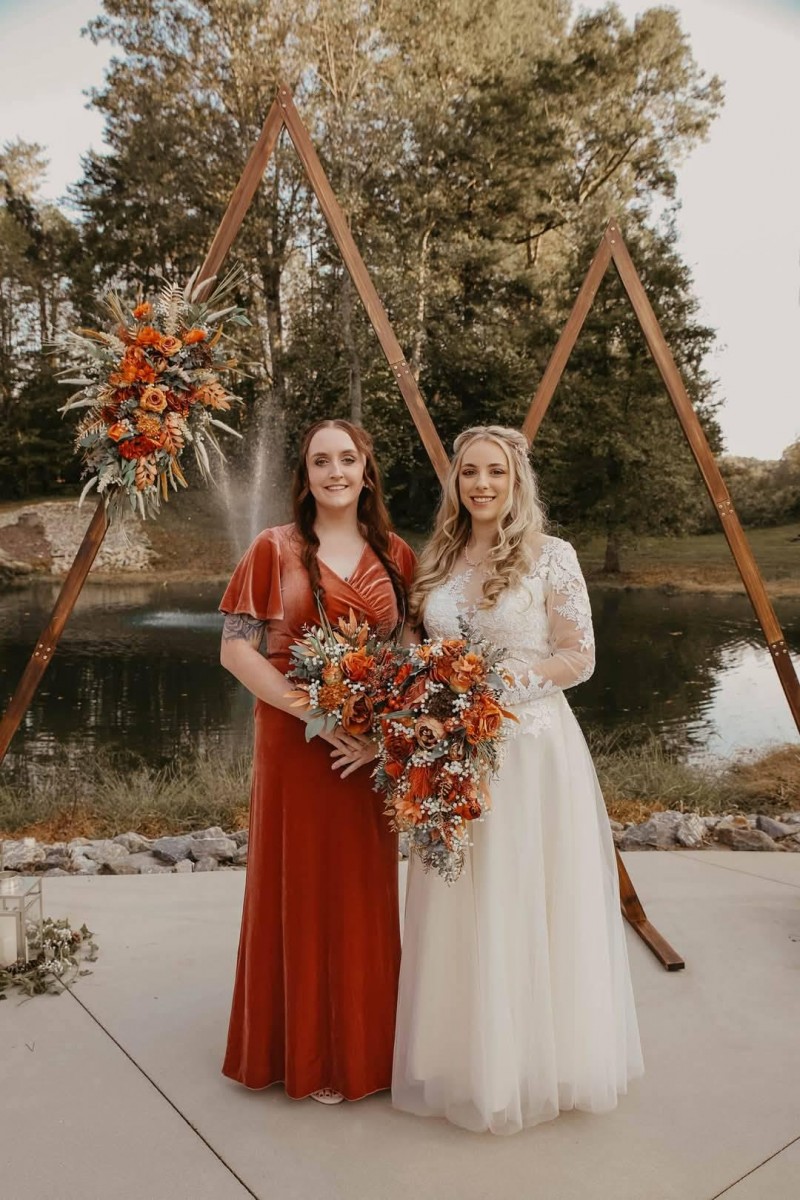 Cascading bridal bouquet and floral arch in rust, terracotta, and burnt orange with silk flowers1080-1200
