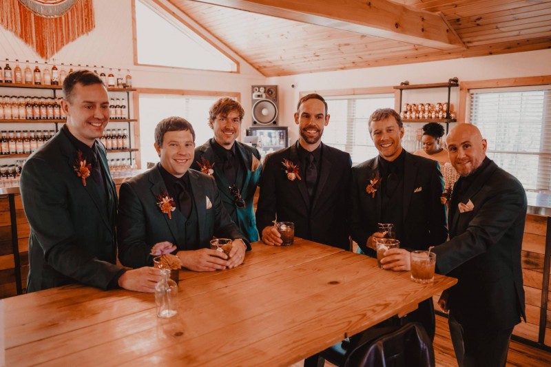 Groom and groomsmen boutonnieres in burgundy and terracotta wedding color palette2048-533.203125