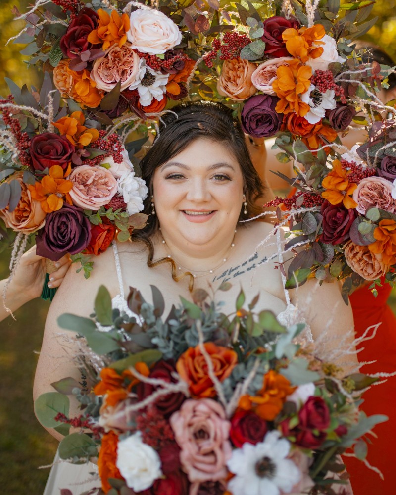 Bridal bouquet surrounded by bridesmaids holding bouquets in burgundy, rust, ivory, and cinnamon colors2399-1000.4168403501