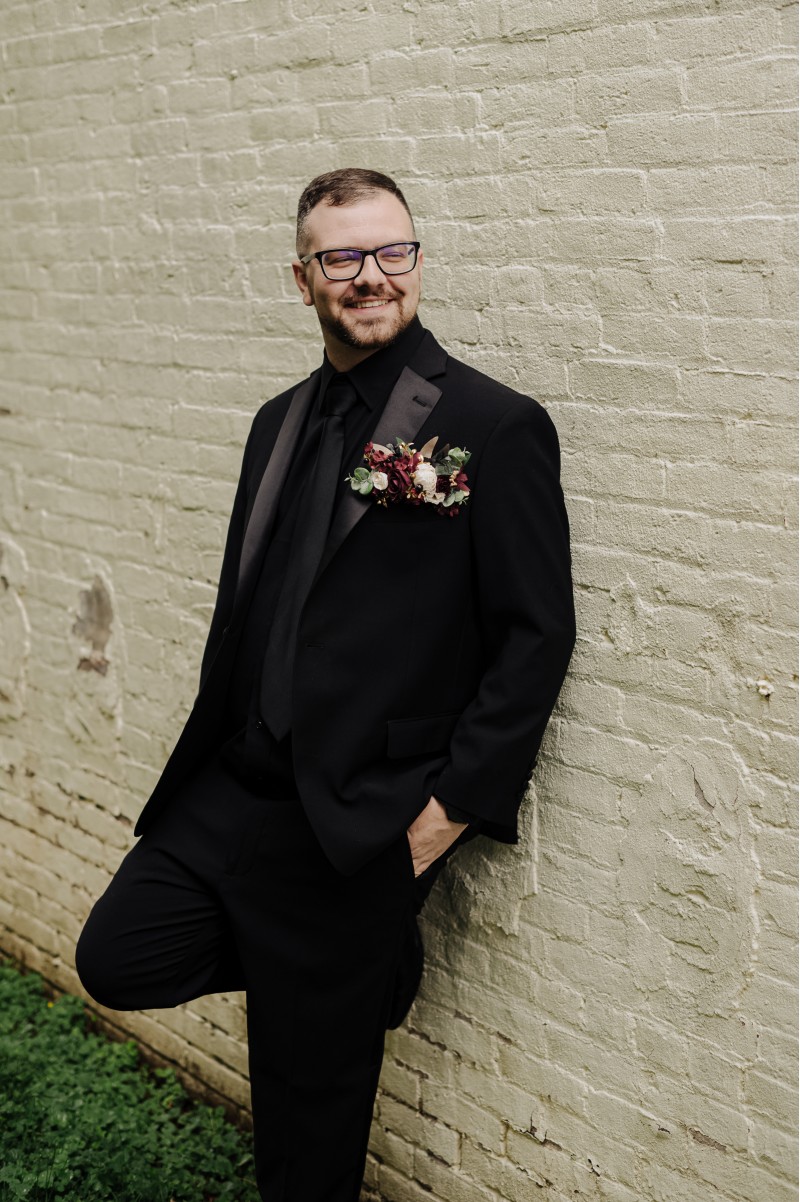 Groom’s boutonniere in burgundy, gold, and black with ivory floral detail3756-1202.3429179979