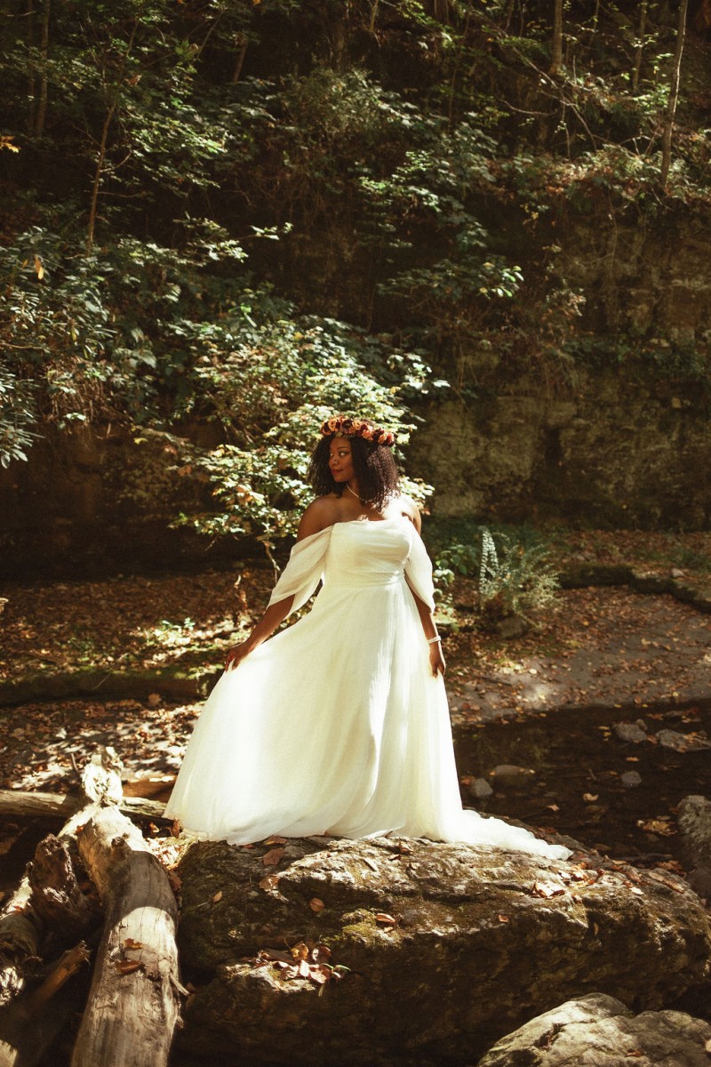 Bride wearing a rust, burgundy, and cinnamon flower crown in a natural forest setting for an intimate autumn wedding1024-1200