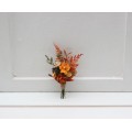 Wedding boutonniere in terracotta, rust and orange colors