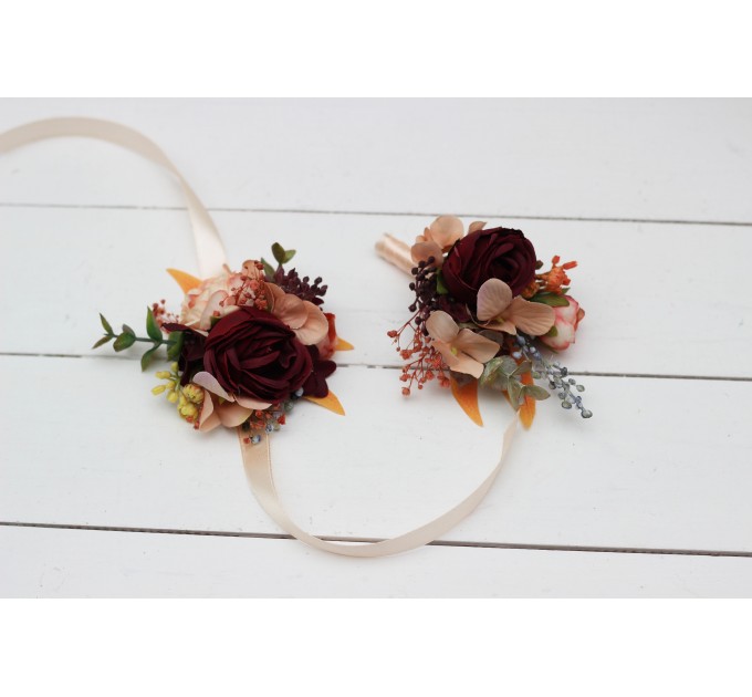 Wedding boutonnieres and wrist corsage in burgundy orange color scheme. Flower accessories. 5042
