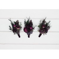Wedding boutonnieres and wrist corsages in a black, purple, and magenta color palette. Floral accessories for a bold and elegant look.  5370