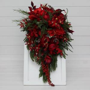 Winter cascading wedding bouquet with red flowers and pine branches. Bridal flowers. Artificial flowers bouquet.  5438